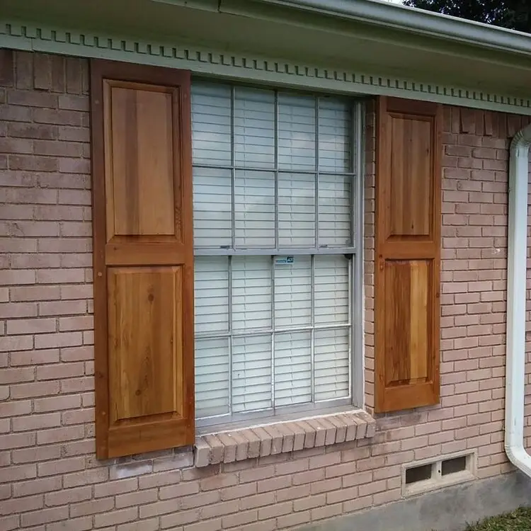 Close-up of a solid cedar shutter installation