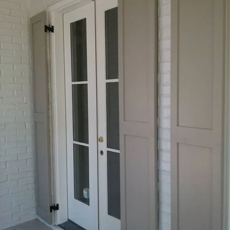 Flat panel wood shutters beside a door