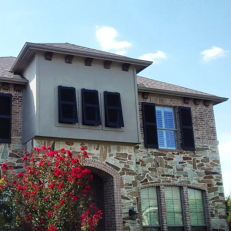 Bahama-style shutter on a home exterior