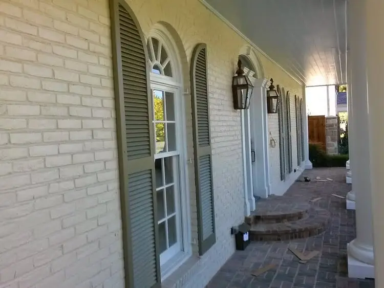 Louvered arched-top shutters on a home